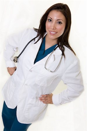 simsearch:400-05172792,k - Full body of an attractive young brunette Hispanic woman health care worker standing with a smiling friendly expression wearing white lab coat with stethoscope Foto de stock - Royalty-Free Super Valor e Assinatura, Número: 400-04009448