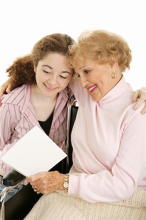Grandmother in wheelchair reading a mother's day (or get well) card from her granddaughter.  White background. Stock Photo - Budget Royalty-Free & Subscription, Code: 400-04009635