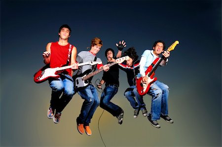simsearch:400-05169559,k - Young crazy group of musicians jumping with instruments Foto de stock - Super Valor sin royalties y Suscripción, Código: 400-04009911