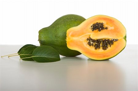 Picture of a papaya over a white table Stock Photo - Budget Royalty-Free & Subscription, Code: 400-04000451