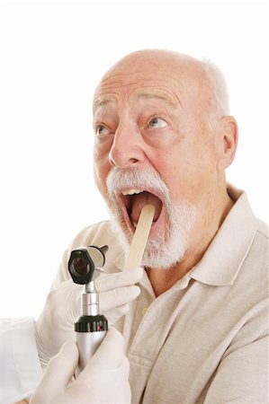 Senior man opening his mouth for the doctor to look in his throat.  White background. Stock Photo - Budget Royalty-Free & Subscription, Code: 400-04000470