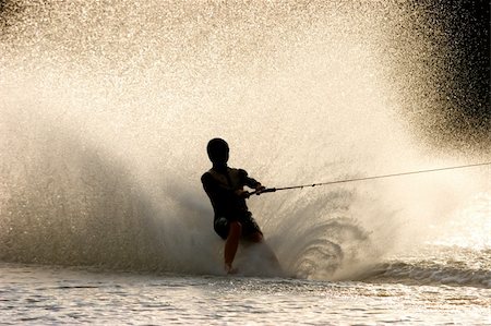 Silhouette of a barefoot water skier with backlit water spray Stock Photo - Budget Royalty-Free & Subscription, Code: 400-04000511