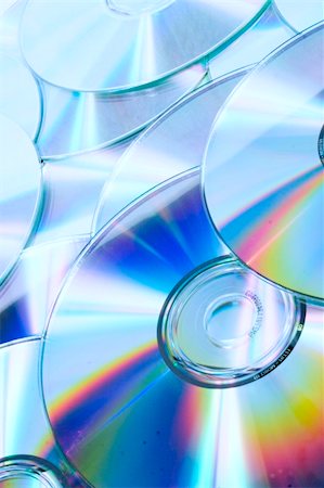 Many overlapping CDs with a rainbow hue on a white background. Stock Photo - Budget Royalty-Free & Subscription, Code: 400-04000780