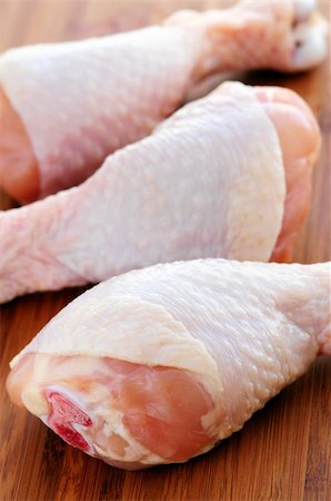raw chicken on cutting board - Raw chicken drumsticks on a wooden cutting board Stock Photo - Budget Royalty-Free & Subscription, Code: 400-04000923