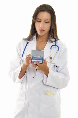 simsearch:400-04508758,k - A beautiful female doctor looking up medical information on a portable device. Foto de stock - Super Valor sin royalties y Suscripción, Código: 400-04000951