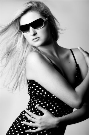 simsearch:400-05041629,k - Beautiful girl with a pair off sunglasses in the studio Fotografie stock - Microstock e Abbonamento, Codice: 400-04001741