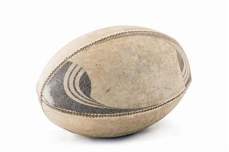 A well used and worn rugby ball. Isolated on white with clipping path attached. Photographie de stock - Aubaine LD & Abonnement, Code: 400-04001932