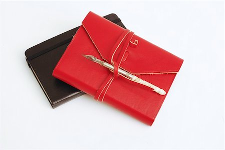 simsearch:400-04783872,k - An old red diary with a calligraphy pen on top -  white background Photographie de stock - Aubaine LD & Abonnement, Code: 400-04002734