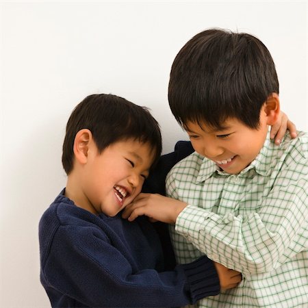 Two young Asian brothers playing and laughing. Stock Photo - Budget Royalty-Free & Subscription, Code: 400-04003009