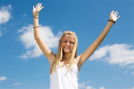 portrait photo teenage girl long blonde hair'''' - Enthusiastic young teen girl raising her arms in celebration against a blue sky. Stock Photo - Budget Royalty-Free & Subscription, Code: 400-04003114