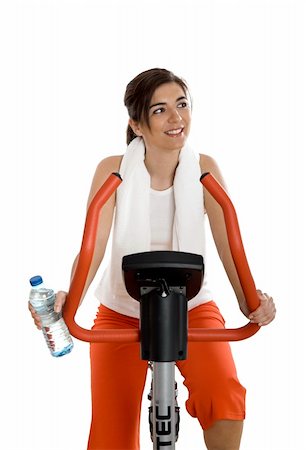 simsearch:400-07103428,k - Young woman training on exercise bike at the gym whit a bottle of water on the left hand Photographie de stock - Aubaine LD & Abonnement, Code: 400-04003195