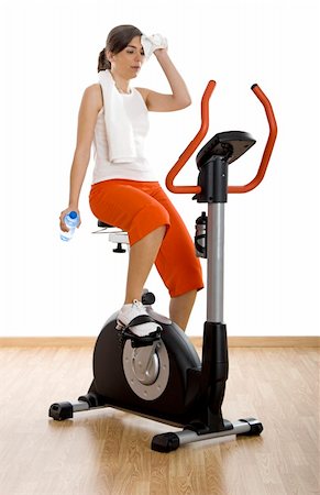 simsearch:400-04027186,k - Young woman tired of training on exercise bike at the gym Stockbilder - Microstock & Abonnement, Bildnummer: 400-04003196