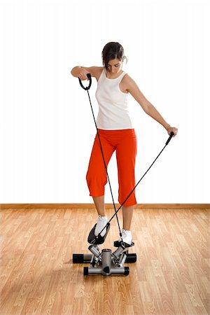 simsearch:400-07627460,k - Beautiful young woman making exercise on the gym Photographie de stock - Aubaine LD & Abonnement, Code: 400-04003201