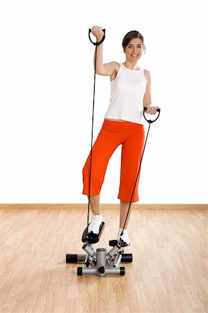 simsearch:400-07627460,k - Beautiful young woman making exercise on the gym Photographie de stock - Aubaine LD & Abonnement, Code: 400-04003202