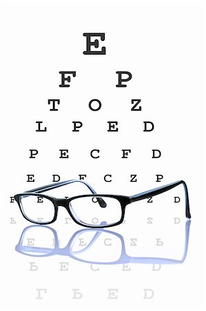 simsearch:400-08407302,k - Eye glasses reflected, with optometrist chart on background. Stock Photo - Budget Royalty-Free & Subscription, Code: 400-04003663