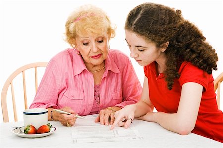 Teen girl helping her grandmother read the fine print on the absentee ballot.  Isolated on white. Stock Photo - Budget Royalty-Free & Subscription, Code: 400-04003779
