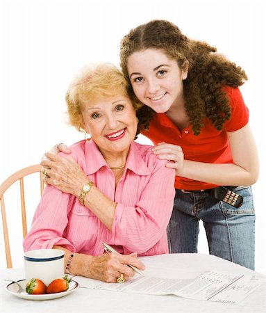 Teen girl helping her grandmother fill out an absentee ballot.  Isolated on white. Stock Photo - Budget Royalty-Free & Subscription, Code: 400-04003783