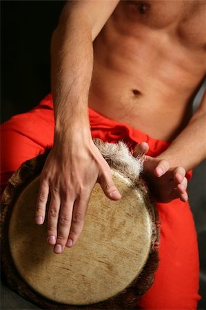 simsearch:400-08493198,k - Man playing the djembe (nigerian drum) in studio Photographie de stock - Aubaine LD & Abonnement, Code: 400-04014835