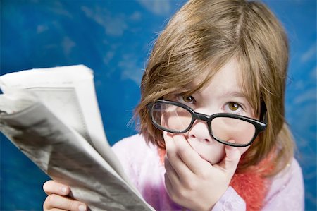 simsearch:400-05197146,k - Shocked Young Girl Dressed Up in Reading Glasses Reading a Newspaper Stock Photo - Budget Royalty-Free & Subscription, Code: 400-04015698