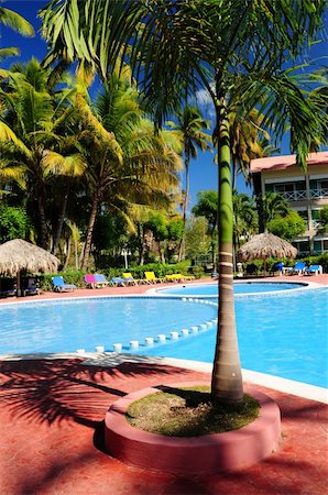 simsearch:862-03732412,k - Swimming pool and hotel with palm trees at tropical resort Stock Photo - Budget Royalty-Free & Subscription, Code: 400-04016172
