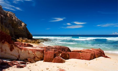 simsearch:400-04423269,k - Red coloured rocks on pristine beach Photographie de stock - Aubaine LD & Abonnement, Code: 400-04016291