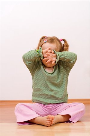 fussy baby - Little girl hiding behind her hands - sad or playful, with copyspace Stock Photo - Budget Royalty-Free & Subscription, Code: 400-04016328