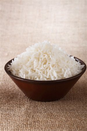 plain white rice bowl  on brown rustic background, Low Key Lighting Technique, Shallow DOF Foto de stock - Royalty-Free Super Valor e Assinatura, Número: 400-04016439