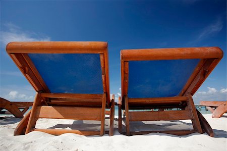 simsearch:400-06914796,k - Wooden deckchairs on a tropical beach with nice blue sky Stock Photo - Budget Royalty-Free & Subscription, Code: 400-04017424