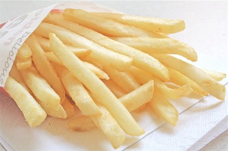 simsearch:400-08096195,k - French Fries the ultimate Fast Food Snack of the masses Stock Photo - Budget Royalty-Free & Subscription, Code: 400-04017479