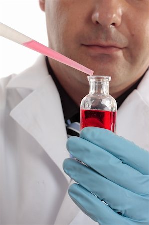 simsearch:400-04962353,k - A scientist, chemist or pharmacist conducting laboratory research. Focus to bottle and pipette. Stock Photo - Budget Royalty-Free & Subscription, Code: 400-04017589