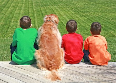 Three Boys and a Dog Sitting on a Deck Stock Photo - Budget Royalty-Free & Subscription, Code: 400-04018541