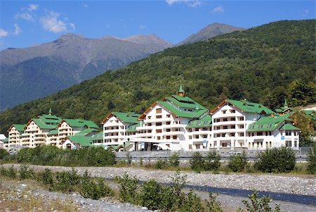 shanin (artist) - Long white house cwith green roof on the river bank in Krasnaya Polyana, Sochi, Russia Stock Photo - Budget Royalty-Free & Subscription, Code: 400-04018755