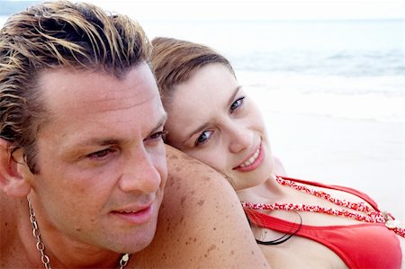 simsearch:400-05227851,k - a portrait of attractive couple having fun on the beach. Focused on girl’s face. Fotografie stock - Microstock e Abbonamento, Codice: 400-04018857