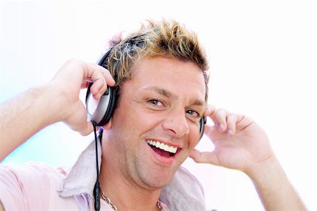 simsearch:400-04842256,k - view of young  male listening music via earphones. Image may contain slight multicolor aberration as a part of design Photographie de stock - Aubaine LD & Abonnement, Code: 400-04018881