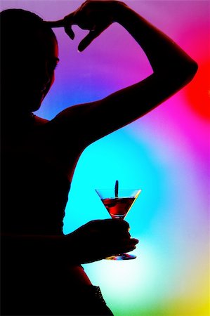 fashion party night discotheque - silhouette of dancing girl with martini glass on colorful back. Image may contain slight multicolor aberration as a part of design Stock Photo - Budget Royalty-Free & Subscription, Code: 400-04018897