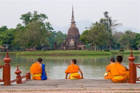 Monk Apprentices looking over the lake at a Buddha Image. Stock Photo - Budget Royalty-Free & Subscription, Code: 400-04019376