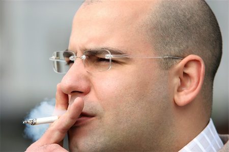 smokers businessman - Close up shot of an smoking man Stock Photo - Budget Royalty-Free & Subscription, Code: 400-04019577