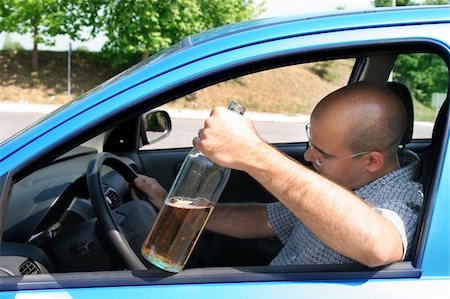 simsearch:400-04947548,k - Drunk man sitting in drivers and holding a bottle alcohol Stock Photo - Budget Royalty-Free & Subscription, Code: 400-04019589