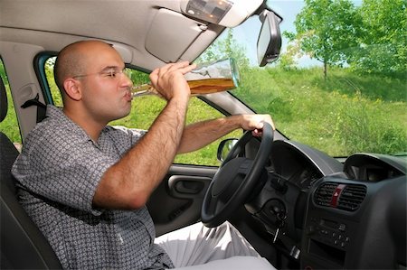 simsearch:400-04947548,k - Drunk man sitting in drivers sit and drinking from a bottle Stock Photo - Budget Royalty-Free & Subscription, Code: 400-04019590