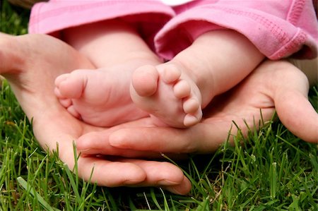 Mother's hands cradling her infant Daughter's feet Stock Photo - Budget Royalty-Free & Subscription, Code: 400-04019604