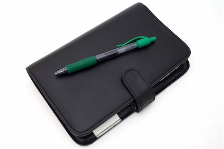 simsearch:400-05028239,k - green pen and a day planner over a white surface Stockbilder - Microstock & Abonnement, Bildnummer: 400-04010112