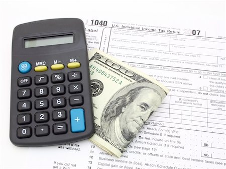 simsearch:400-05140548,k - calculator and dollar bills over 1040 tax form Stock Photo - Budget Royalty-Free & Subscription, Code: 400-04010125