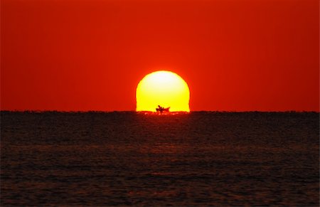 simsearch:400-05255037,k - A new day is beeing born above the ocean with a boat silhouette Stock Photo - Budget Royalty-Free & Subscription, Code: 400-04010259