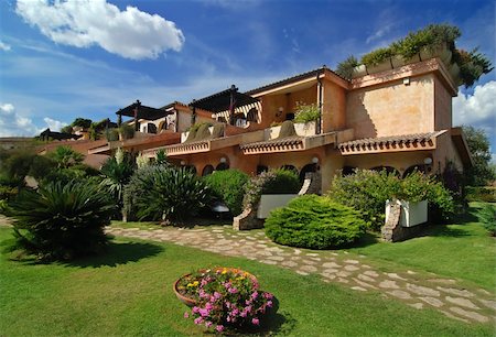 House/hotel in the beautiful summer garden with many plants and path - blue sky with clouds above Stock Photo - Budget Royalty-Free & Subscription, Code: 400-04010329