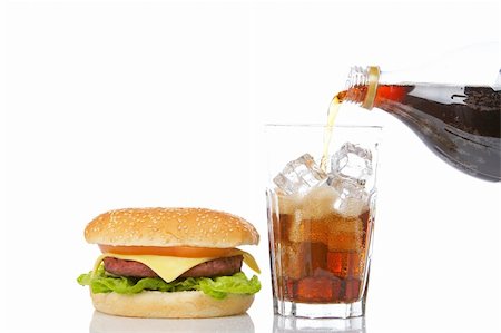 simsearch:400-04035891,k - Cheeseburger with lettuce and tomato and pouring soda into a glass with ice cubes, reflected on white background Fotografie stock - Microstock e Abbonamento, Codice: 400-04011088