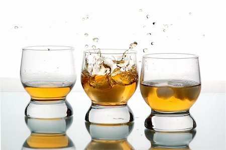 pour of liquor - three glasses with some liquid,white background, close-up Photographie de stock - Aubaine LD & Abonnement, Code: 400-04011341