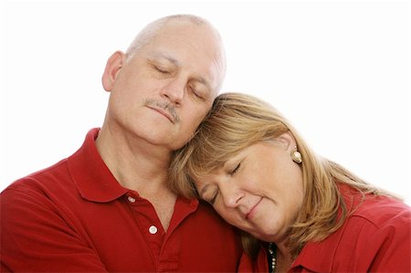 simsearch:400-04033107,k - Mature loving couple cuddling with their eyes closed.  White background. Stock Photo - Budget Royalty-Free & Subscription, Code: 400-04011582