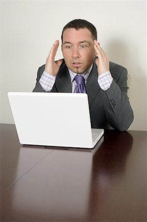 simsearch:400-05209351,k - Shocked businessman in his thirties looking at a bad thing on his laptop. Stock Photo - Budget Royalty-Free & Subscription, Code: 400-04011876