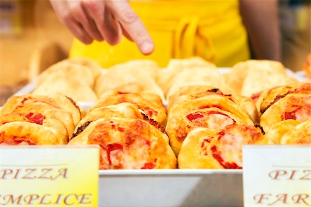 sales clerk in a supermarket pointing a slice of pizza Foto de stock - Super Valor sin royalties y Suscripción, Código: 400-04011946