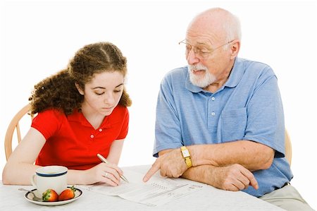 Grandfather helping teen girl fill out paperwork (absentee ballot).  Isolated on white. Stock Photo - Budget Royalty-Free & Subscription, Code: 400-04012080